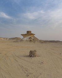 Built structure on sand against sky