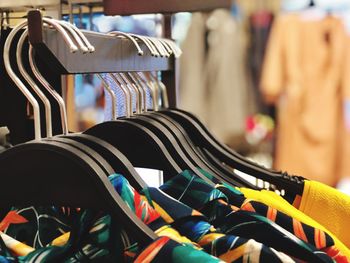 Close-up of clothes for sale on rack at store