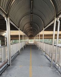 Empty corridor along bridge