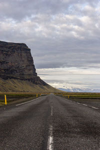 Road by landscape against sky