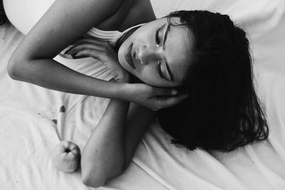 Young woman lying on bed at home