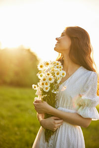 Young woman holding flower