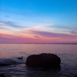 Scenic view of sea at sunset