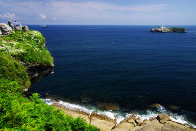 High angle view of sea and rocks against sky