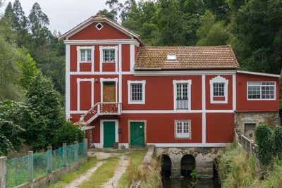 Exterior of house by building against sky