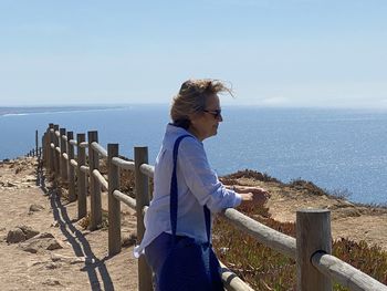 Man looking at sea against sky