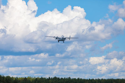 Low angle view of airplane flying against sky