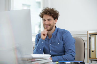 Portrait of smiling man sitting on table