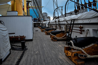 Boats moored at harbor against sky