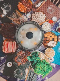 High angle view of steamboat and food on table