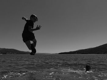 Full length of sea against clear sky
