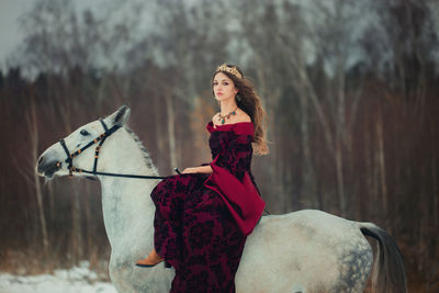 Portrait of young woman riding horse