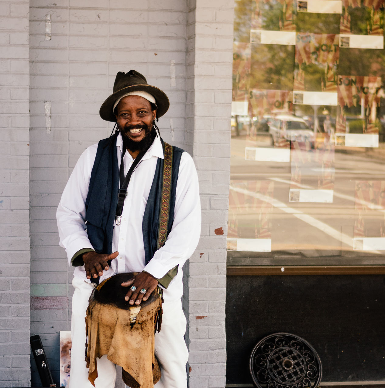 PORTRAIT OF SMILING MAN SITTING AT BUS