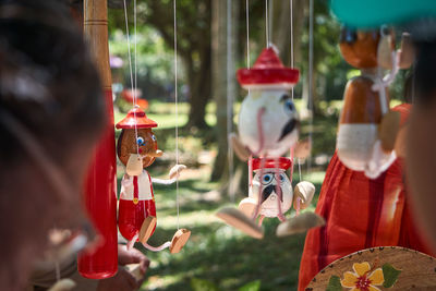Close-up of figurines hanging outdoors