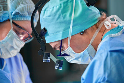 Midsection of doctor examining patient in hospital