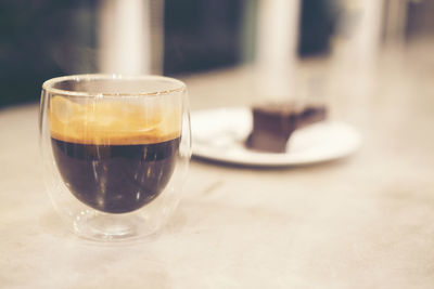 Close-up of coffee in glass on table