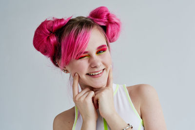 Side view of young woman against white background