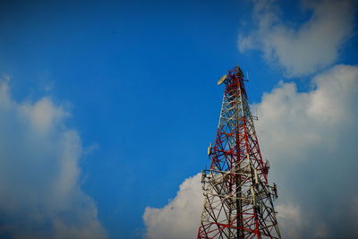 Low angle view of communications tower against blue sky