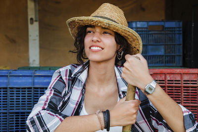 Smiling woman wearing hat looking away