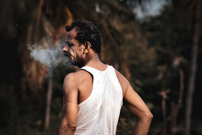 Man looking away while standing on land