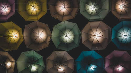 Directly below shot of illuminated umbrellas at night