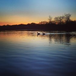 Scenic view of lake at sunset