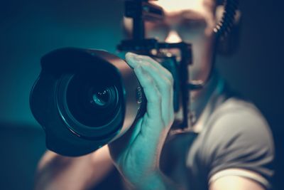 Man operating camera in darkroom