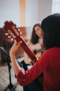 Midsection of woman playing with arms raised