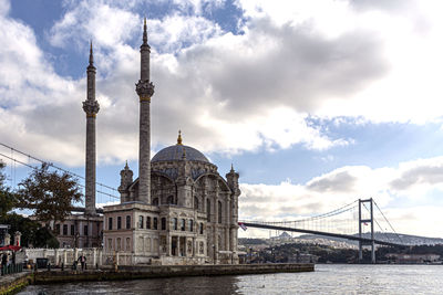 View of bridge over river against cloudy sky