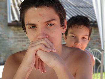 Portrait of shirtless boy looking at camera