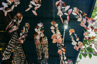 Low angle view of clothes hanging for sale at market stall