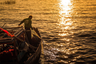 Boat in sea at sunset