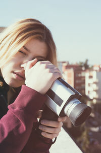 Woman looking filming with camera