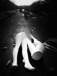 Low section of woman lying on street