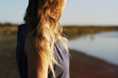 Midsection of woman standing at beach