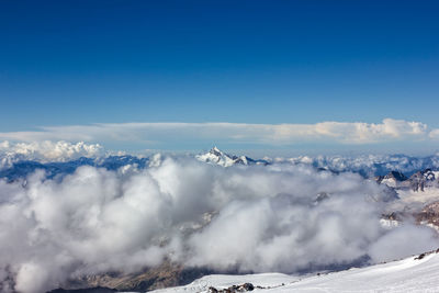 Scenic view of mountains against blue sky