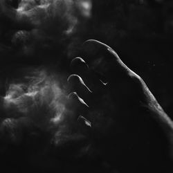 Close-up of hand against sky