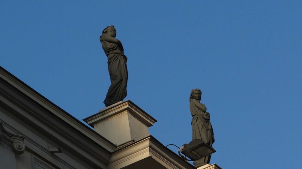 human representation, statue, sculpture, art and craft, art, low angle view, creativity, clear sky, blue, copy space, architecture, built structure, building exterior, monument, outdoors, craft, day, no people