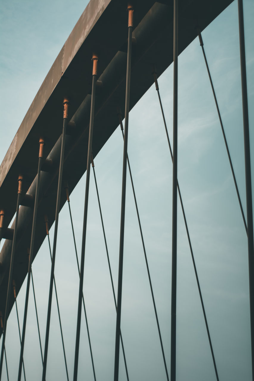 LOW ANGLE VIEW OF BRIDGE IN CITY AGAINST SKY