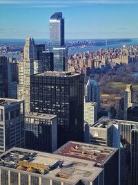 Aerial view of buildings in city against sky