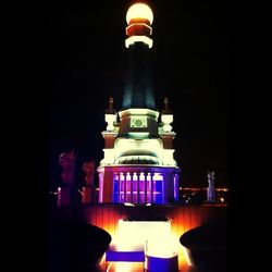 Illuminated statue in city at night