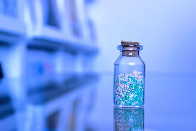 Close-up of small bottle filled with shells