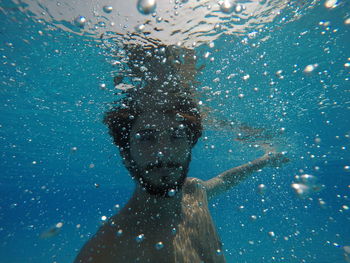 Portrait of man swimming in sea