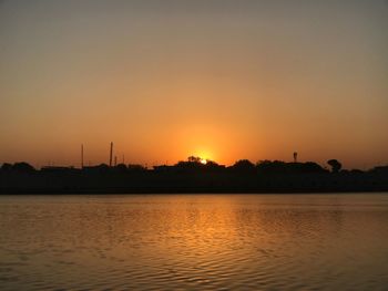 Scenic view of silhouette trees against sky at sunset