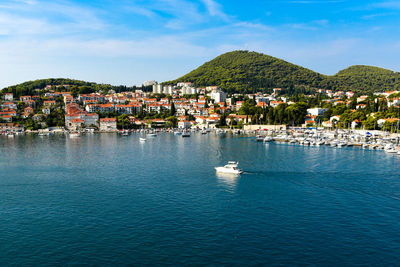 Houses in city against blue sea