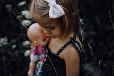 Close-up of girl holding doll