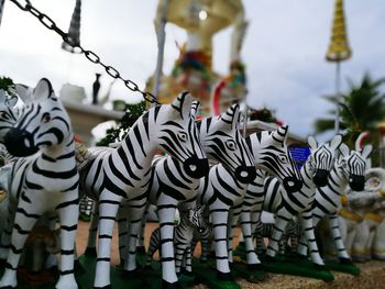 Close-up of zebra figurines on retaining wall