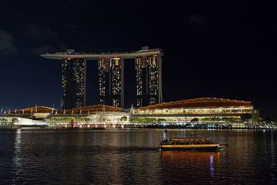 Illuminated city at waterfront