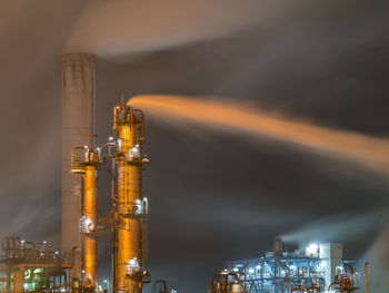 Night view of an oil refinery with a strong wind