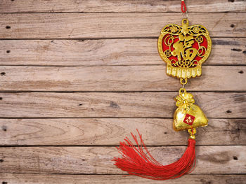 Close-up of heart shape decoration hanging on wood